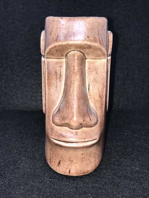 Humorous moai sculpture with pilot helmet